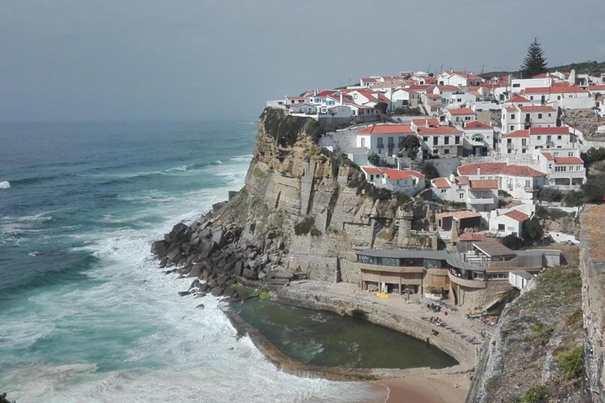 a village on a cliff next to the ocean