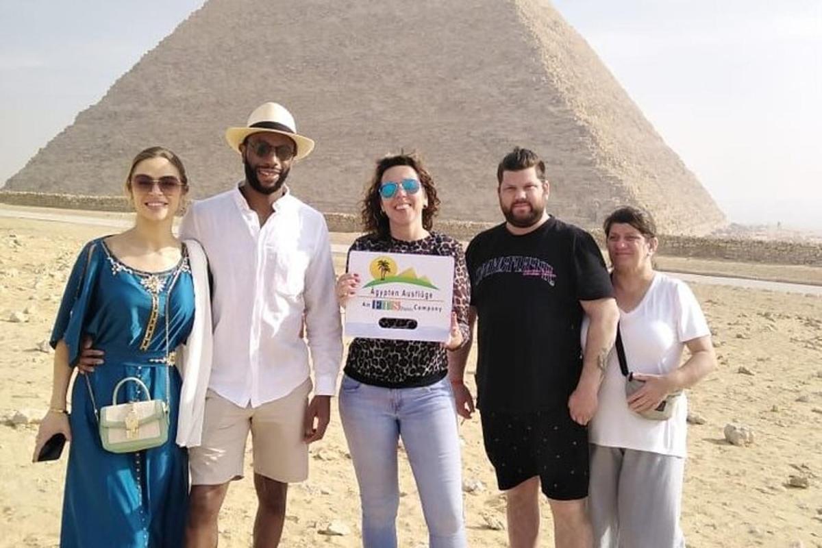 a group of people standing in front of a pyramid