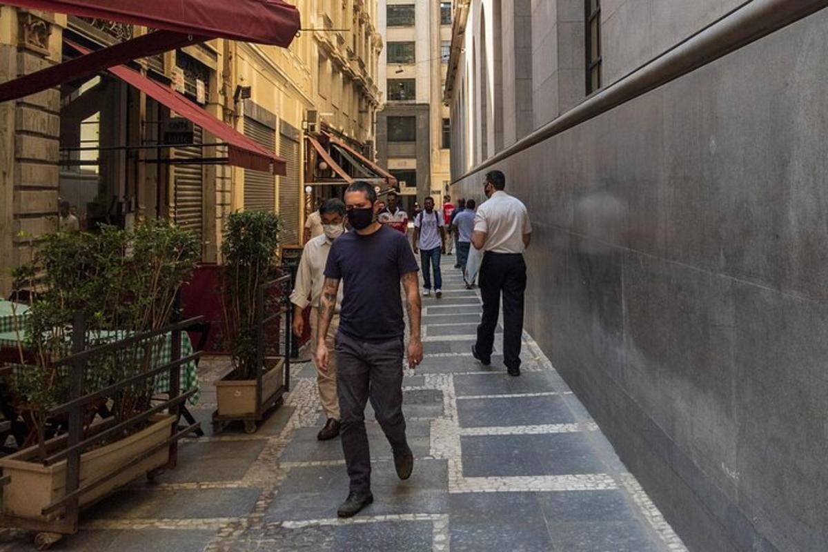 a group of people walking down a city street