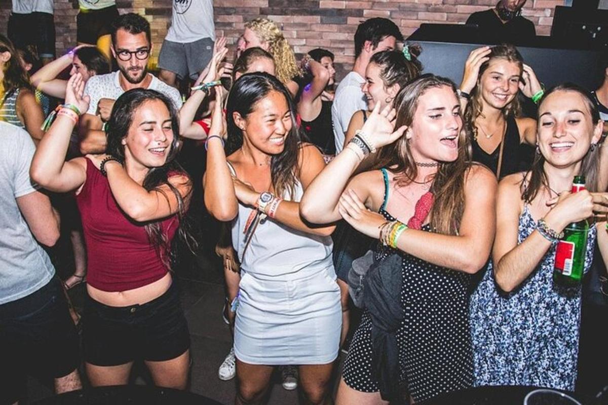a group of women standing in a crowd at a party