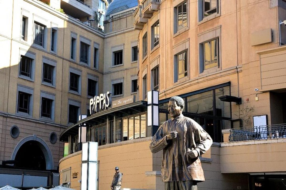 a statue of a man standing in front of a building