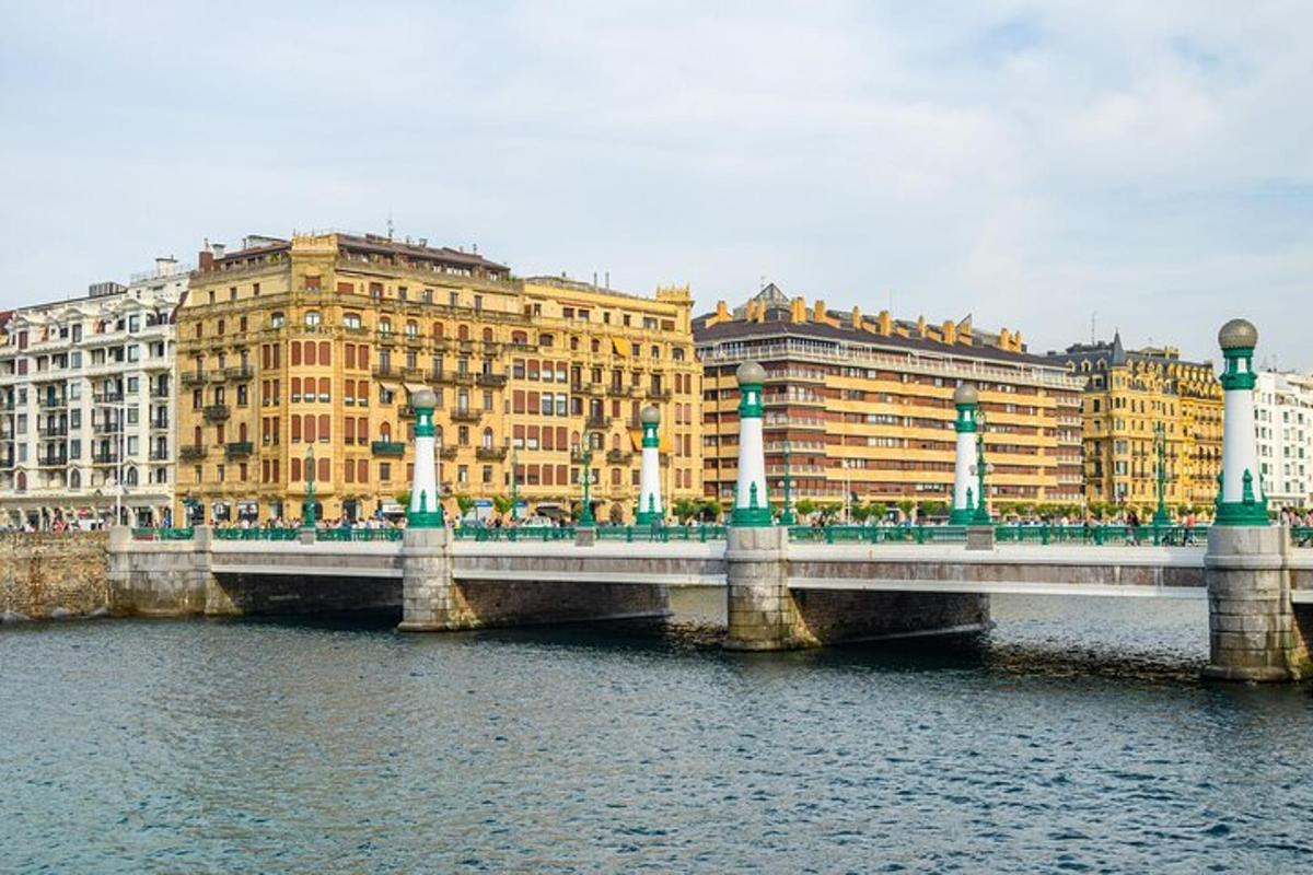 a bridge over a river in front of buildings