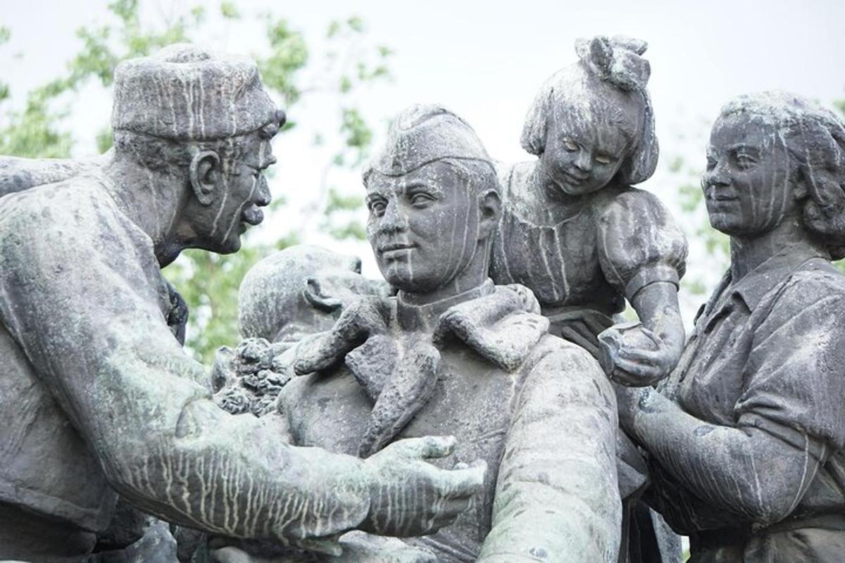 a statue of a group of people holding a baby