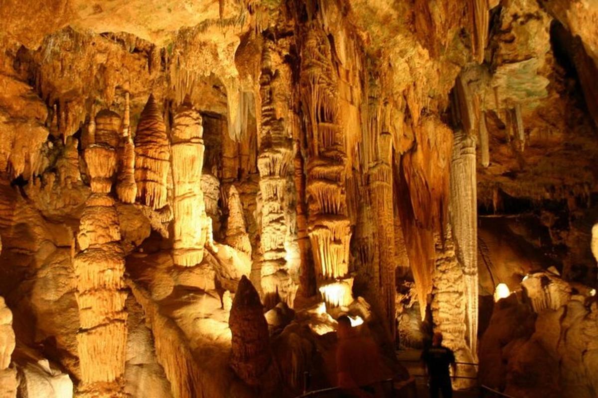 a cave with some people standing inside of it