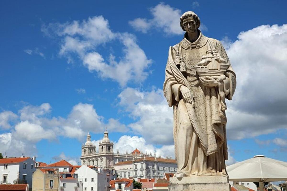 a statue of a man standing in front of a city