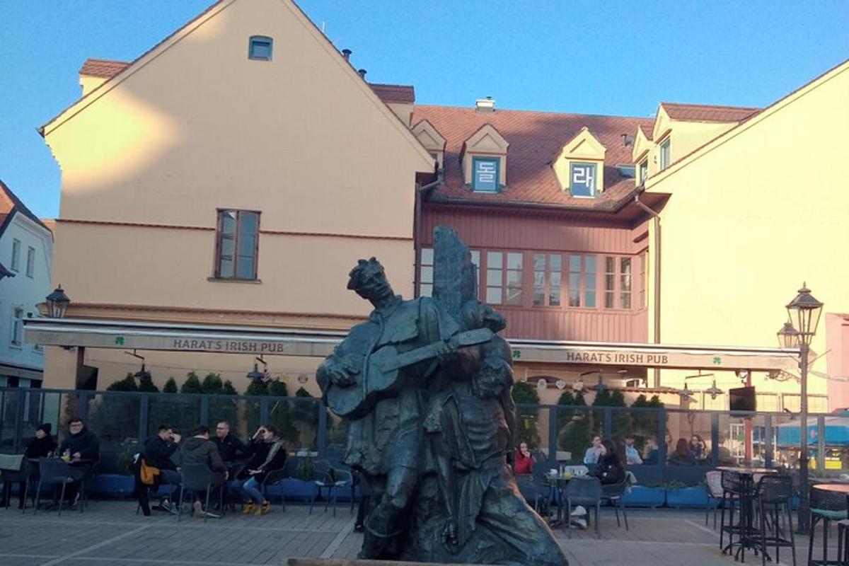 a statue of a man standing in front of a building