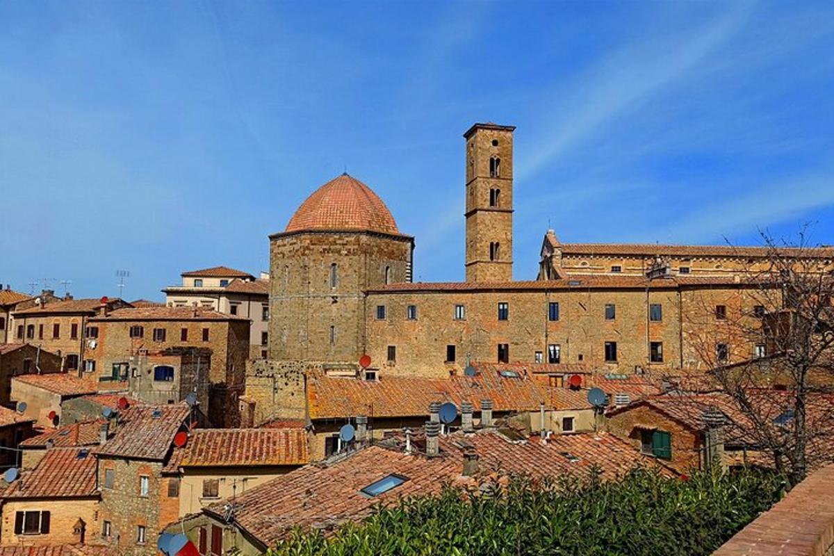 a large building with a clock tower and roofs