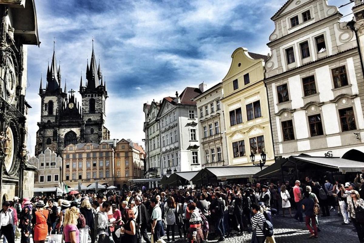 a crowd of people walking around a city with buildings