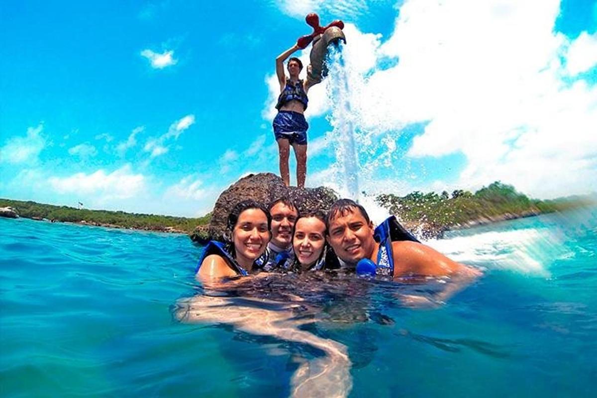 a group of people on a rock in the water