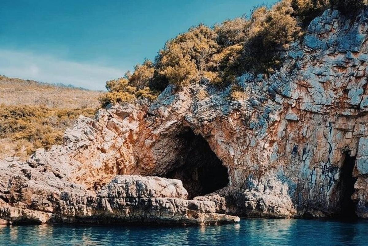 a cave in the side of a rocky cliff