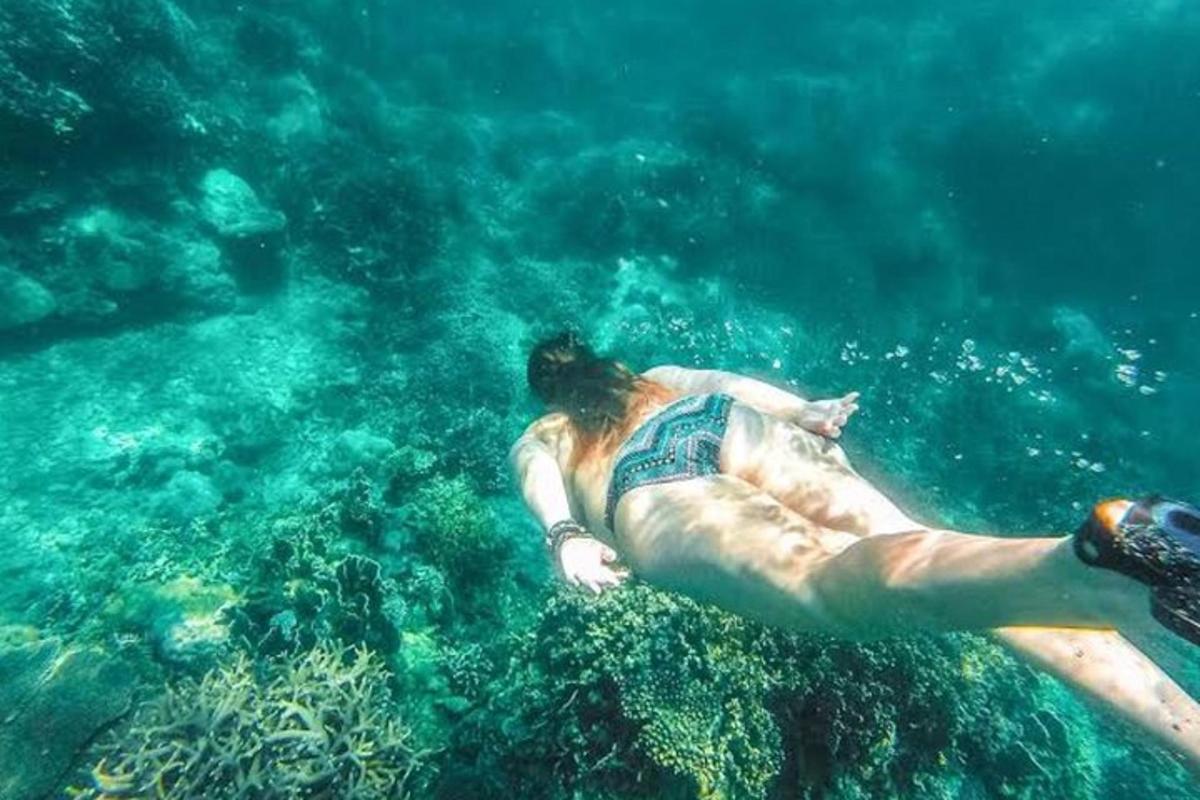a man laying in the water in the ocean