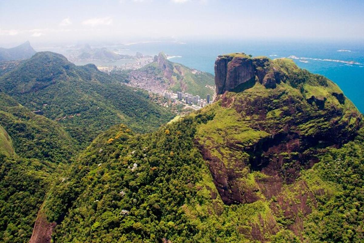 an aerial view of a mountain with the ocean