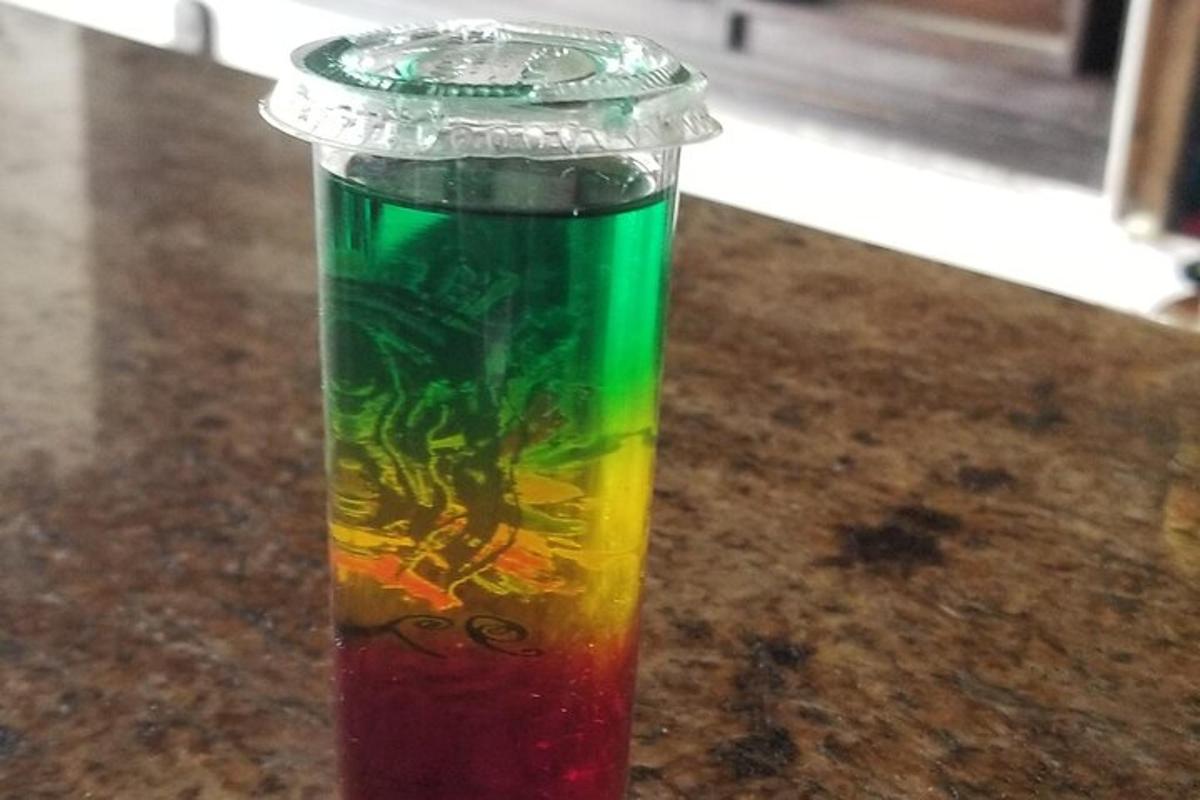 a bottle filled with rainbow liquid sitting on a counter