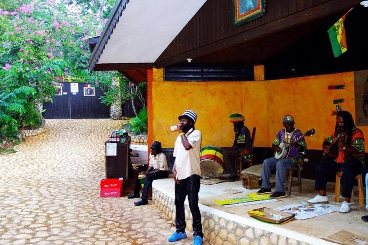 a man standing in front of a group of people playing music