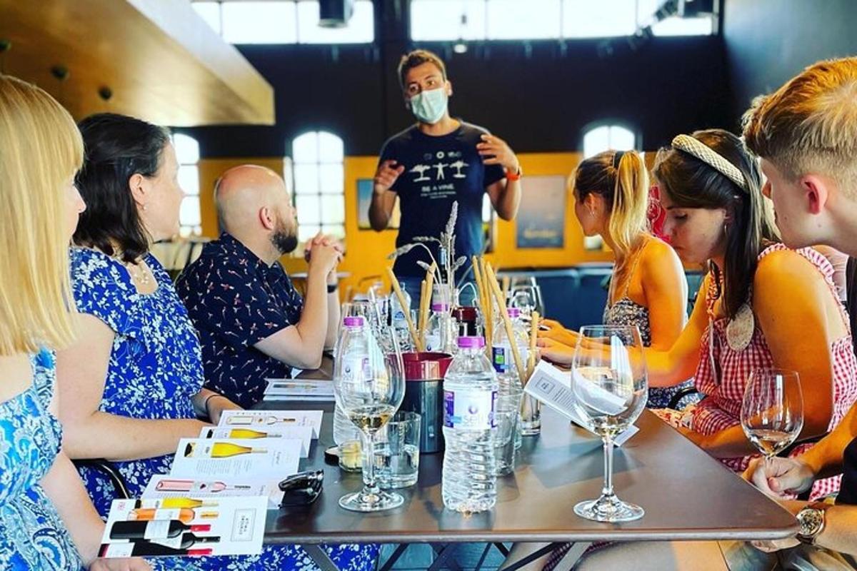 a group of people sitting around a table with wine glasses