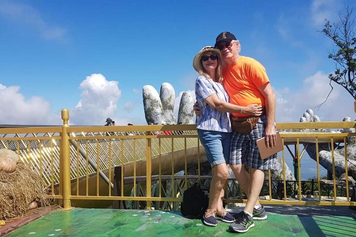 a man and woman posing for a picture at a theme park