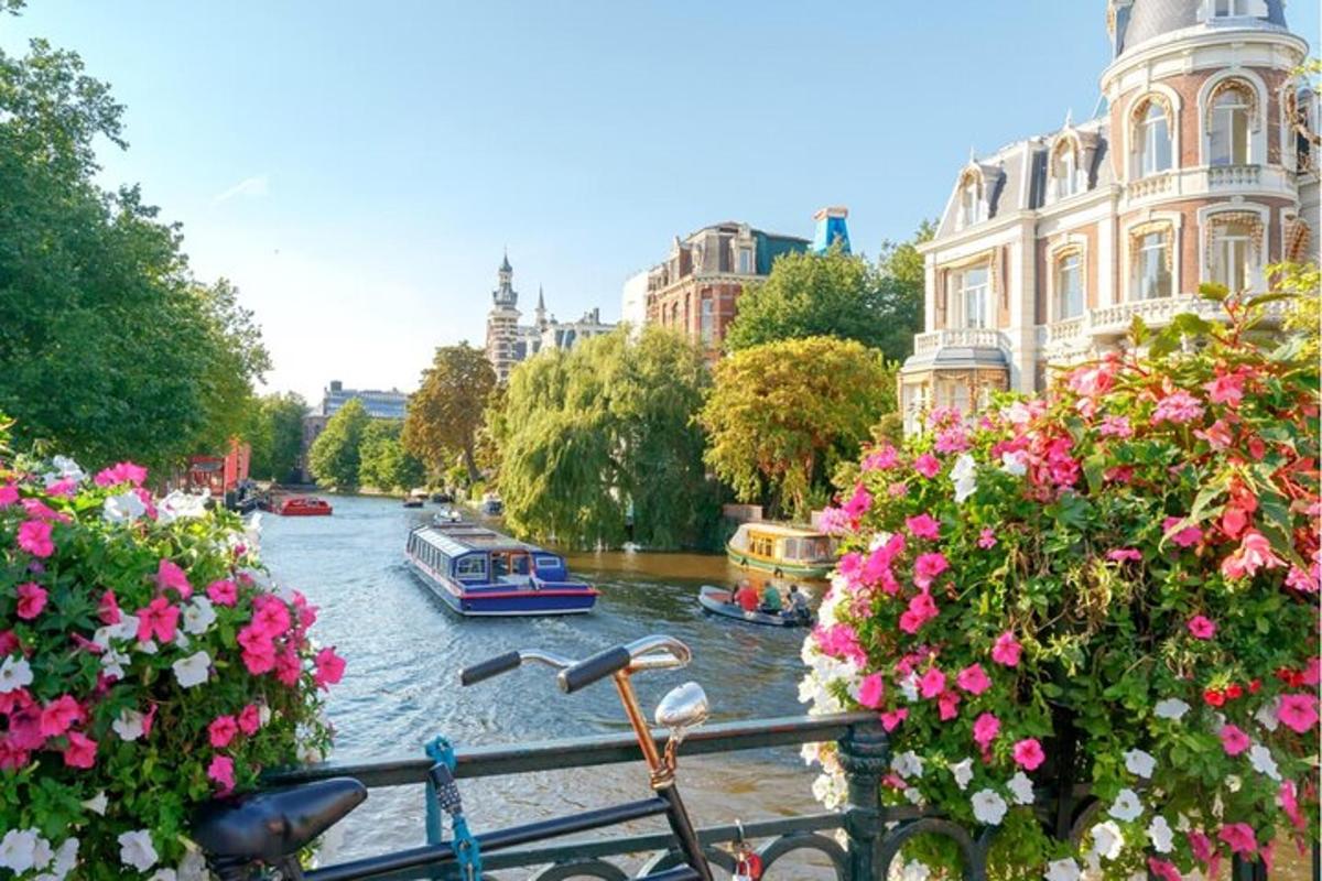 a bike is parked next to a river with boats