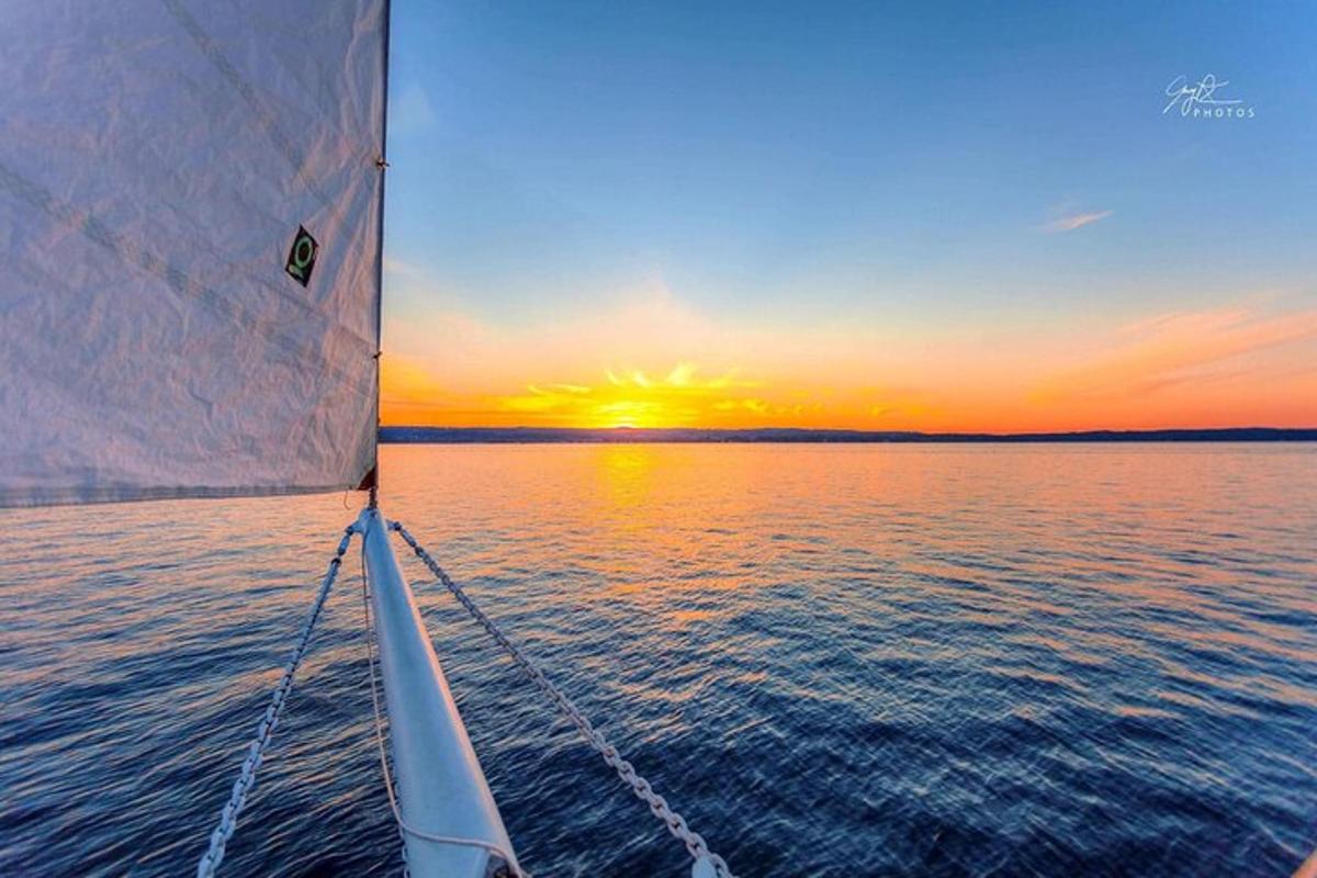 a boat in the water with a sunset in the background