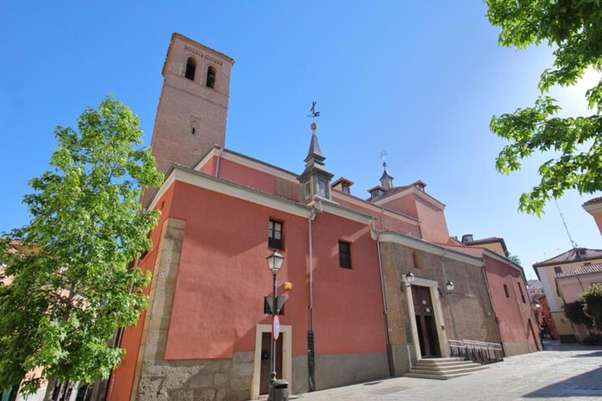 a red building with a clock tower on a street