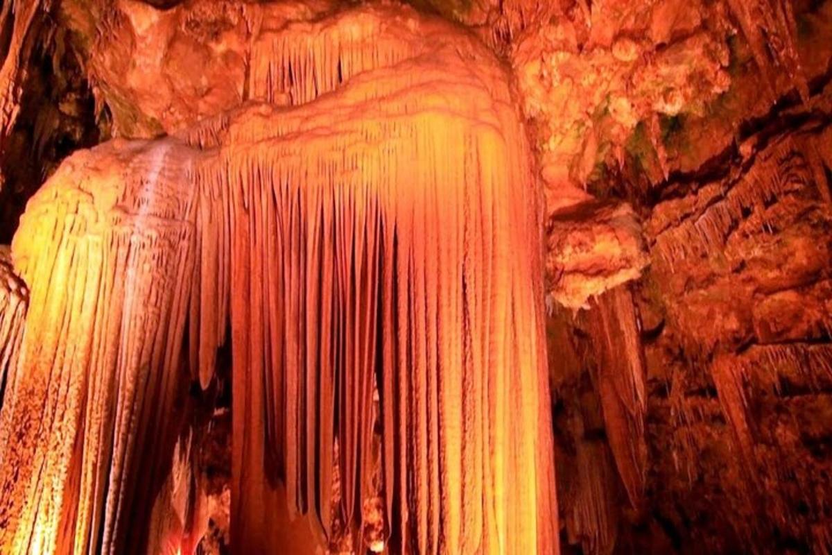 a cave with a large wall of paint on it