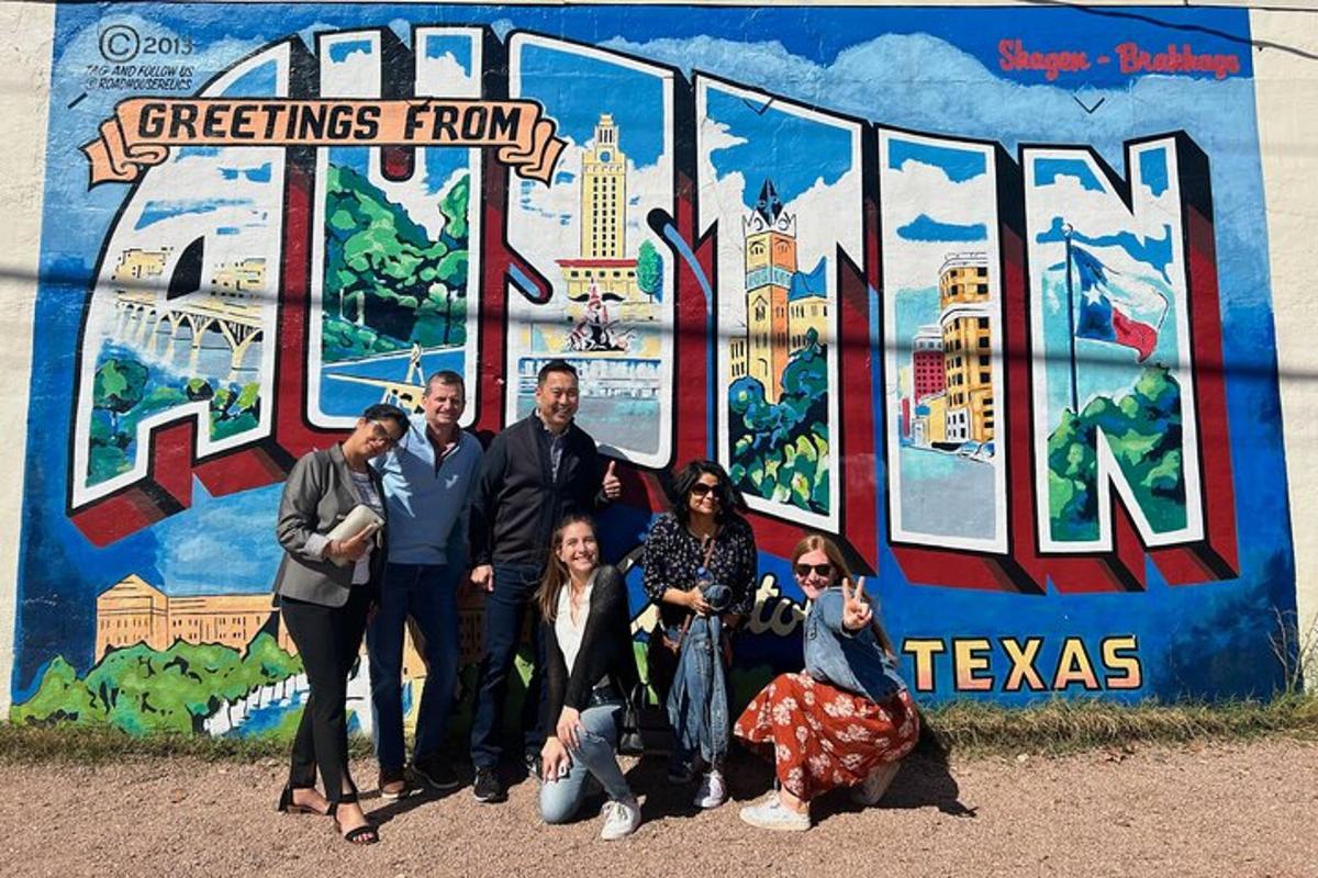 a group of people standing in front of a mural