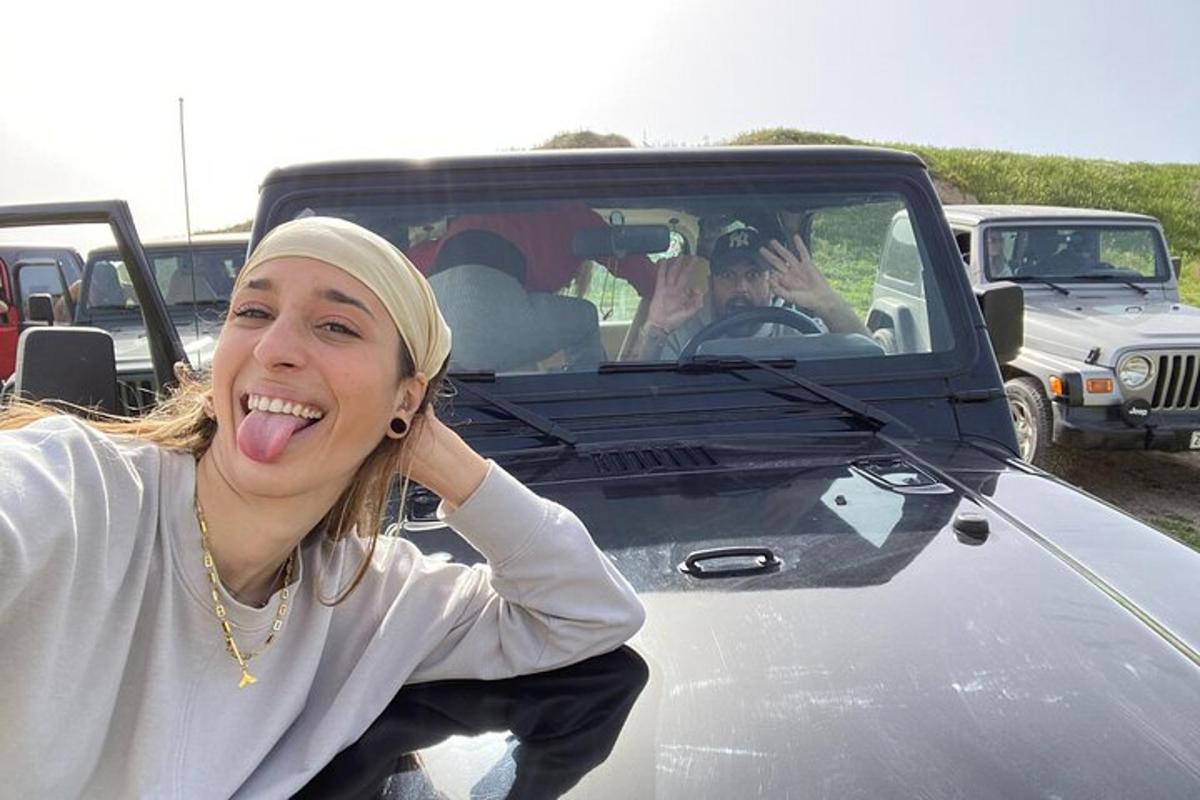 a woman sticking her tongue out while sitting in a car