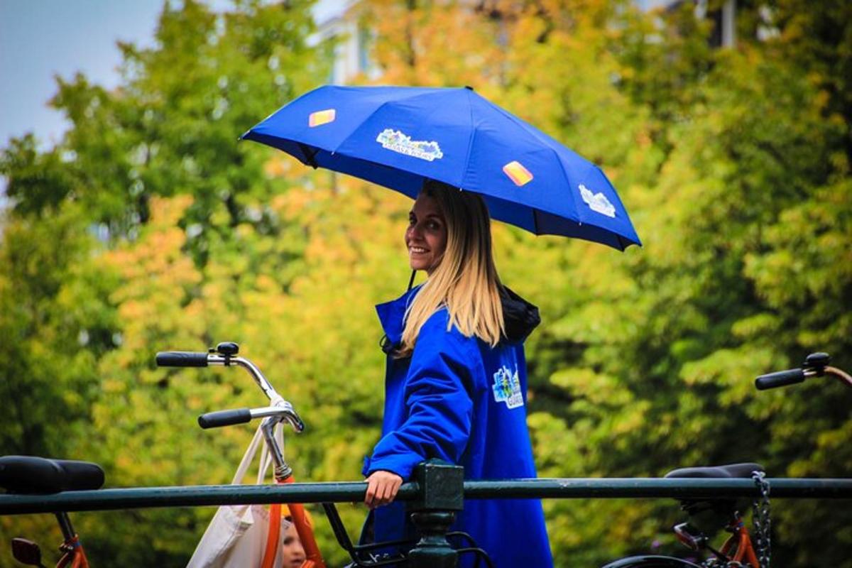 a woman with an umbrella standing next to bikes