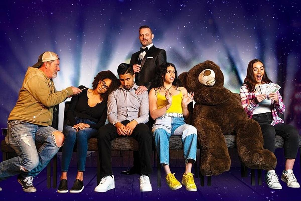 a group of people sitting on a bench with a teddy bear