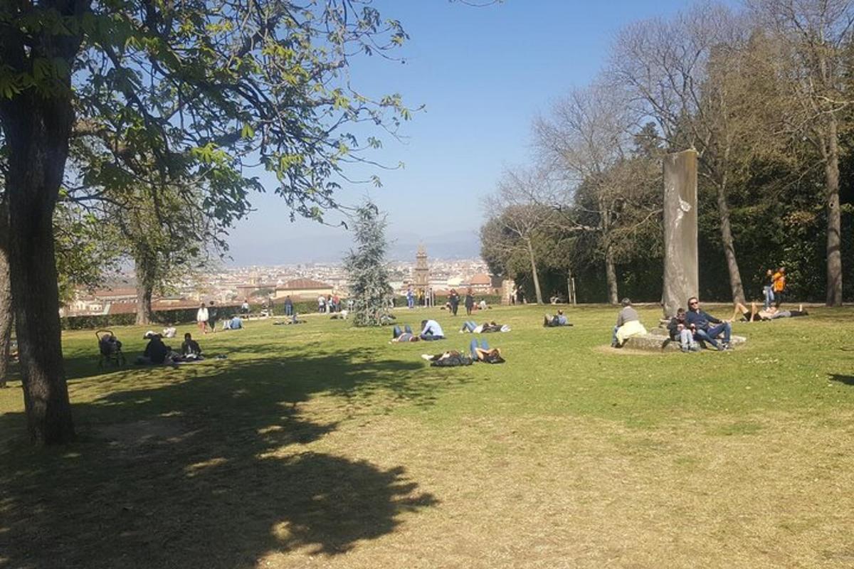 sekumpulan orang duduk di rumput di taman