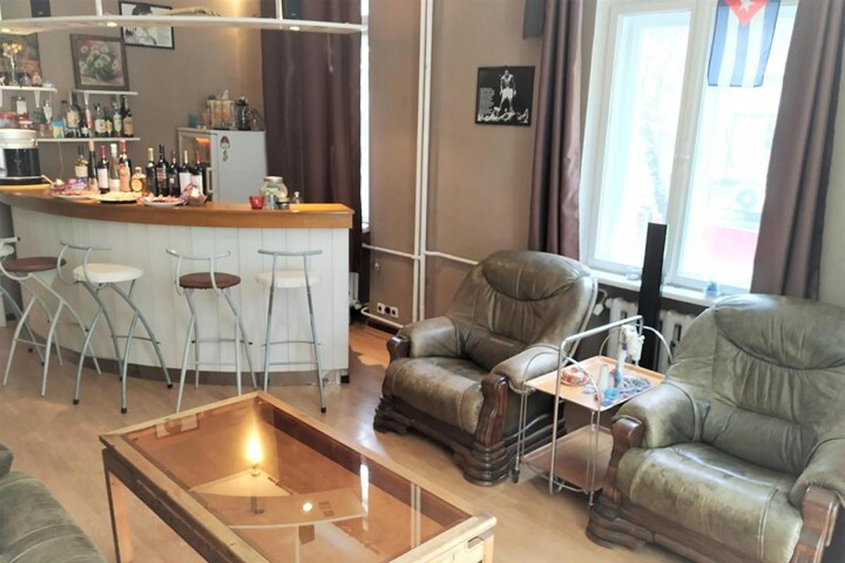 a living room with two chairs and a bar