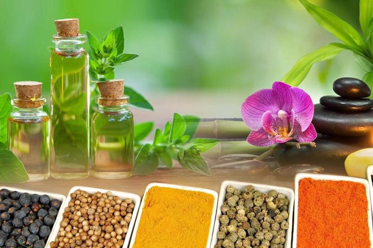 a selection of essential oils and seeds and a flower