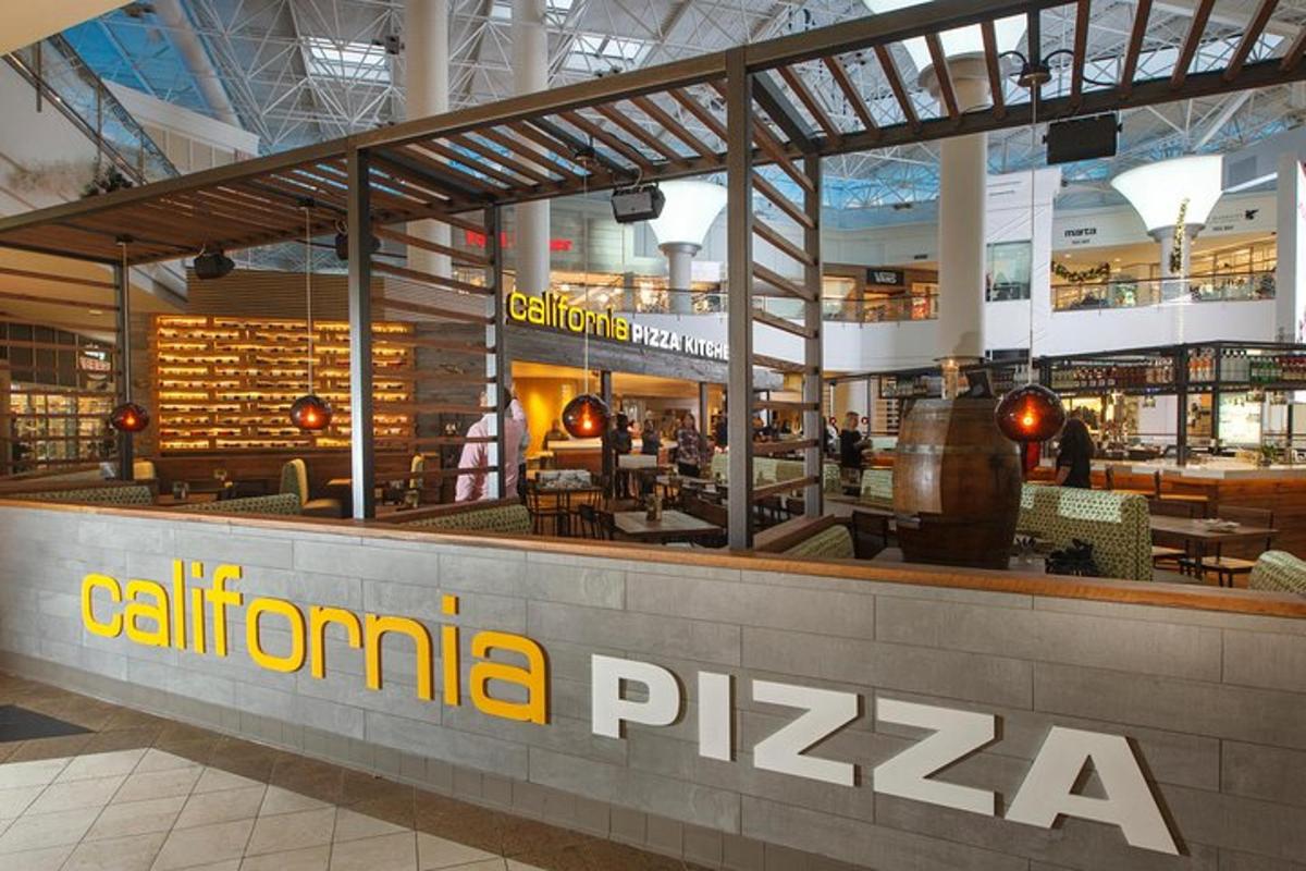 a restaurant in a shopping mall with the words calima pizza