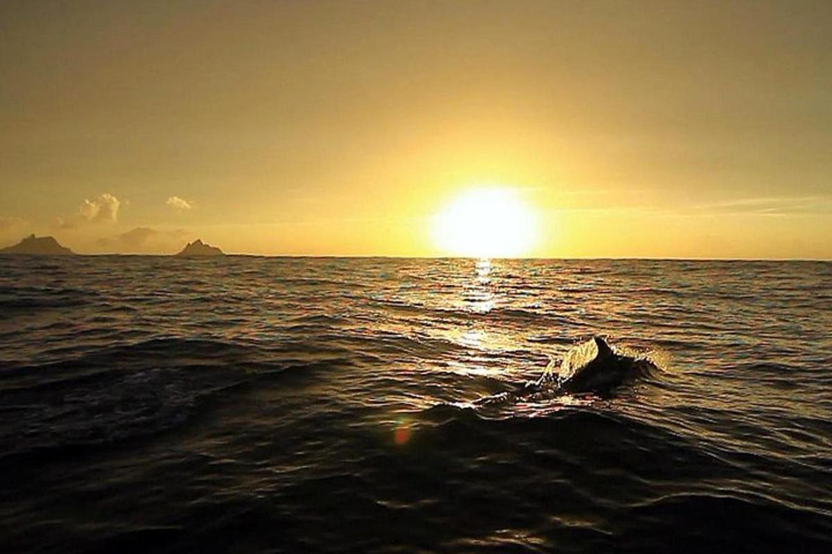 a sunset in the ocean with the sun setting