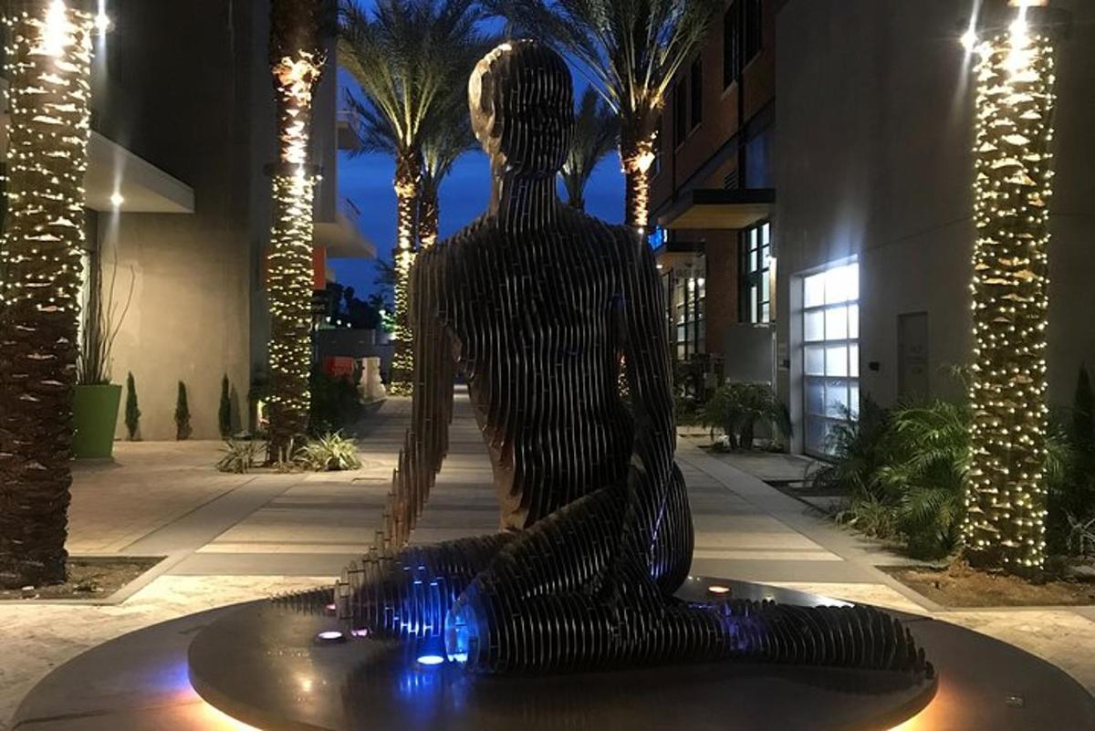 a statue of a woman sitting on a table with blue lights