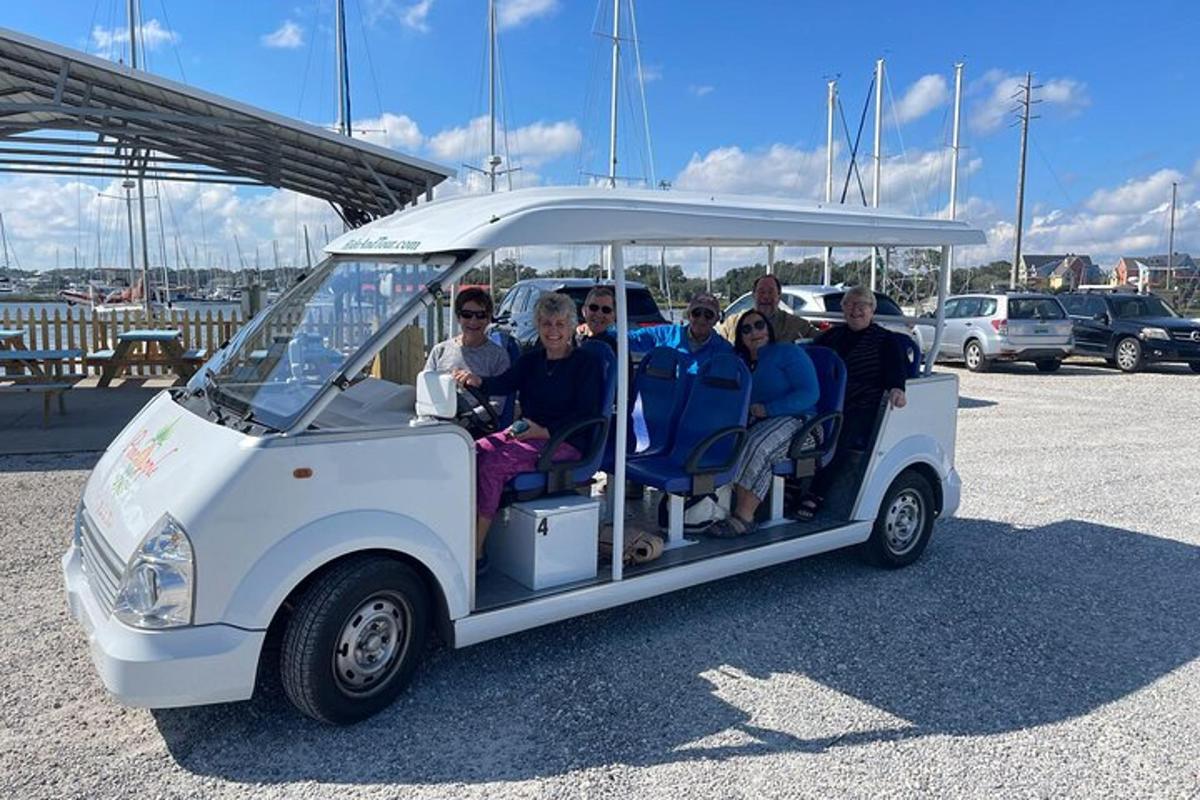 a group of people riding in a golf cart
