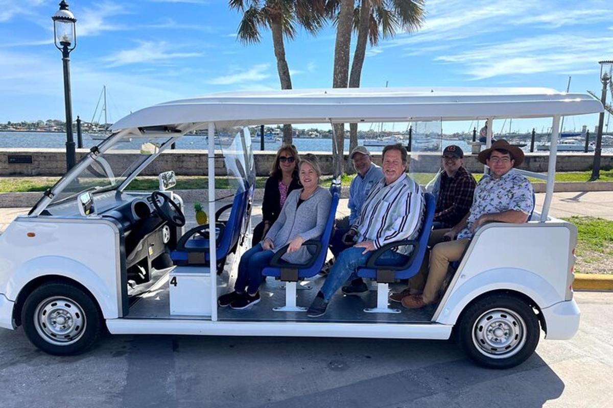 a group of people riding in a golf cart