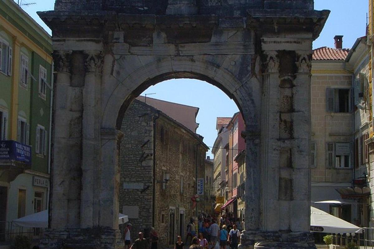 an archway in a city with people walking under it