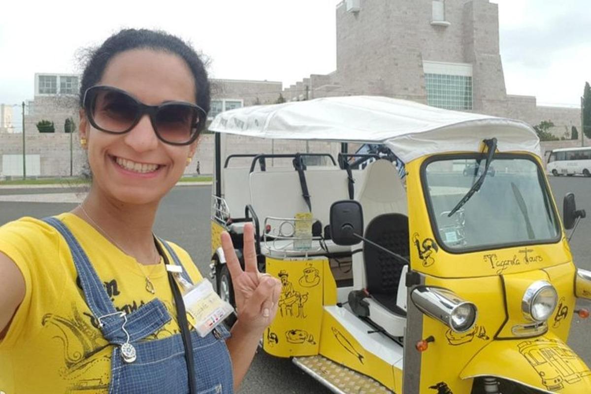 a woman holding a cell phone in front of a golf cart