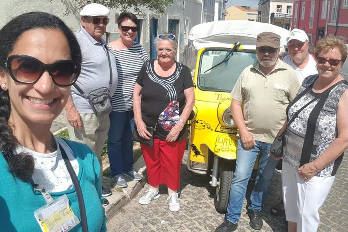 egy csoport ember áll egy sárga autó előtt
