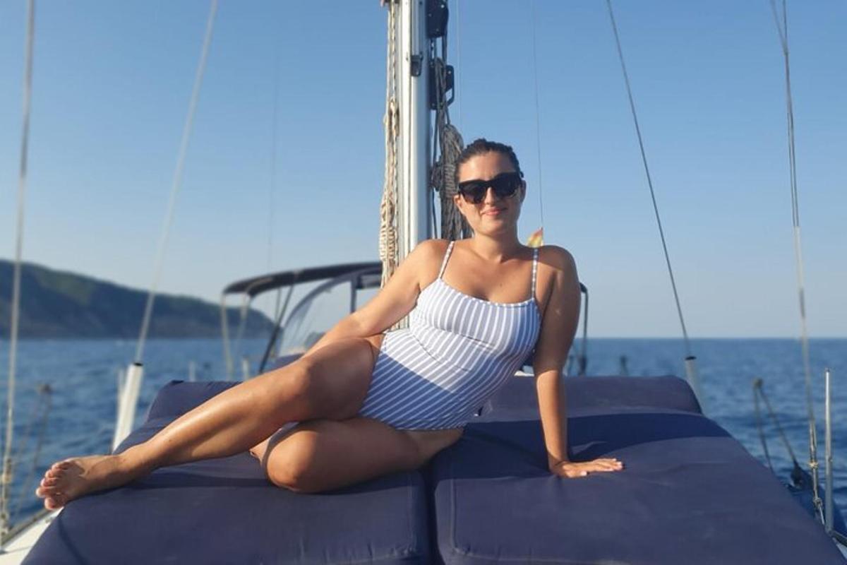 a woman sitting on the back of a boat
