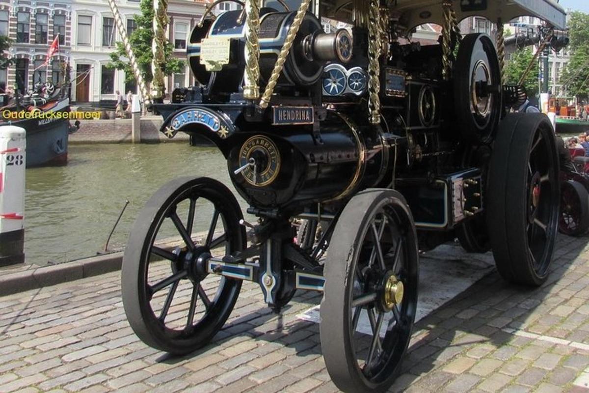 a black carriage with large wheels on a street