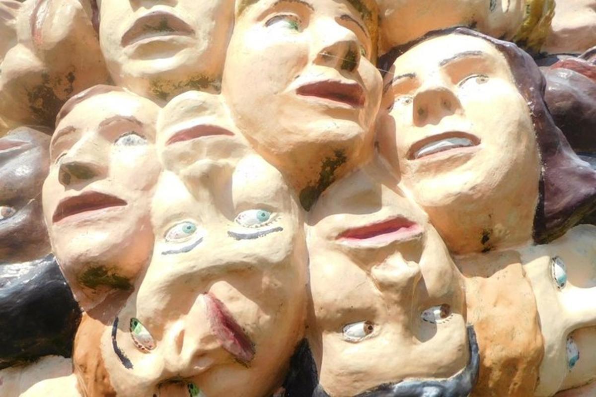 un gruppo di sculture di volti su un muro