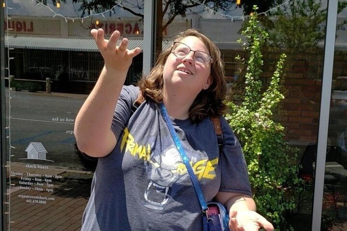 a woman holding her hand up in the air