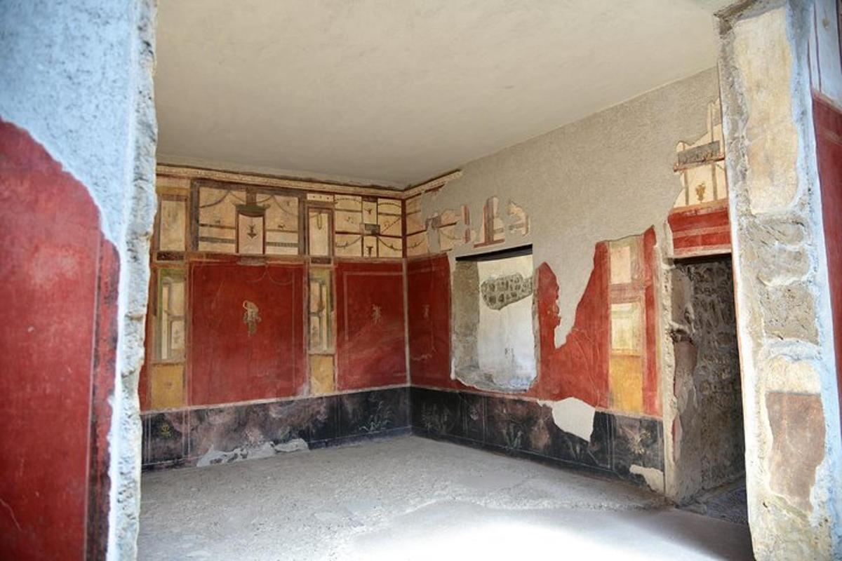 an empty room with a painting on the wall
