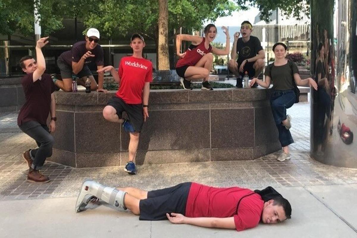 a man laying on the ground in front of a group of people