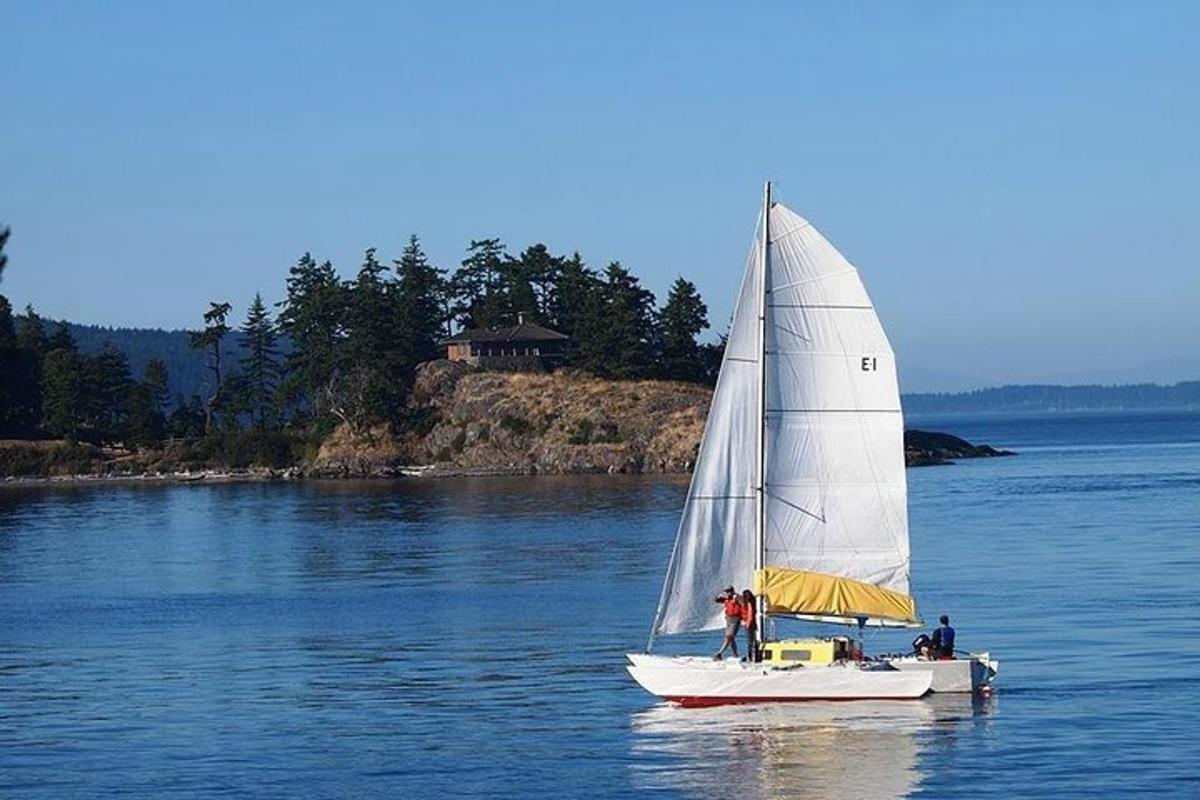 a sailboat in the water with two people on it