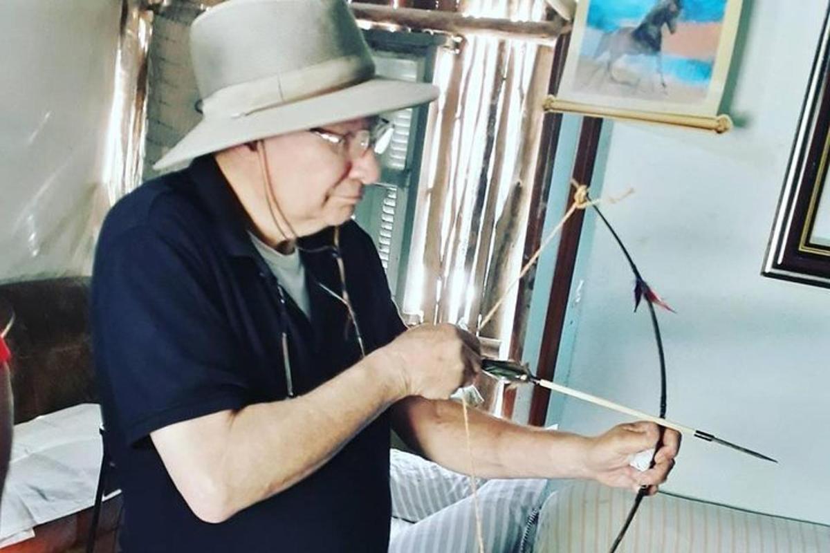 a man in a top hat is holding a stick