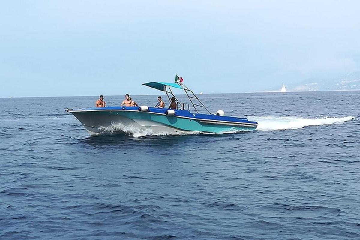 a group of people on a blue boat in the water