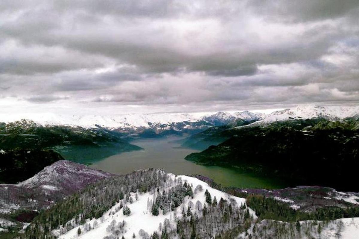 an aerial view of a lake in the mountains