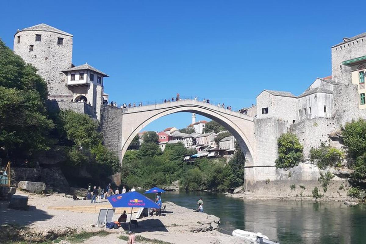 most čez reko z ljudmi, ki sedijo pod dežnikom